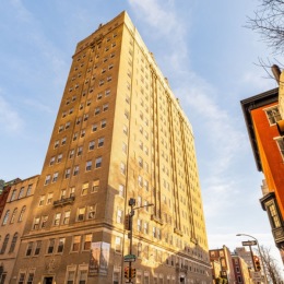 a tall building in front of a blue sky